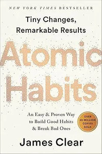The book cover of atomic habits features a bold textured orange title on a light beige background
