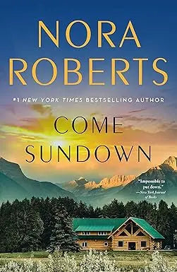 Come sundown book cover by nora roberts features a rustic log cabin with green roof among pines and mountains at sunset