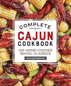 The complete cajun cookbook by ryan bourdeaux features a vibrant cover with red crawfish yellow corn and potatoes