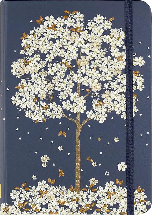 A navy blue falling blossoms journal with a delicate white flower and gold leaf illustration and matching elastic band