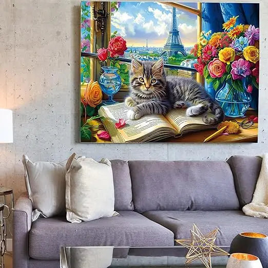 A 1000 piece jigsaw puzzle featuring a fluffy tabby kitten with yellow eyes on a book near flowers and the eiffel tower view