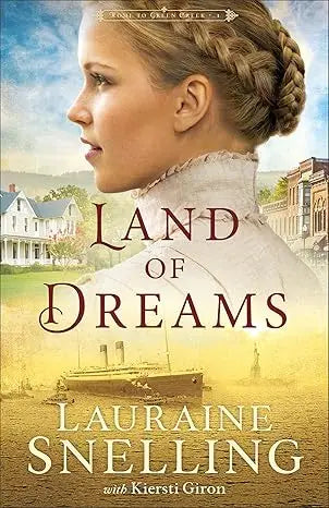 Book cover of land of dreams featuring a woman with blonde braided hair in a white high-necked dress with vintage town and steamboat background