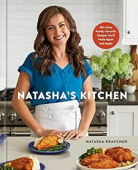 A vibrant blue v-neck blouse with a white apron worn by natasha kravchuk in natashas kitchen product image