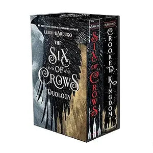 Six of crows boxed set featuring black and gold covers with intricate wing designs including six of crows and crooked kingdom