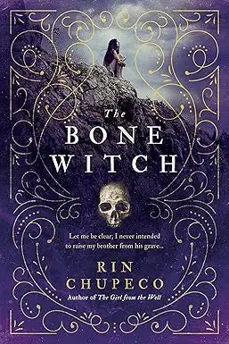 The bone witch book cover features an ornate dark purple design with gold filigree and a figure on a rocky outcrop