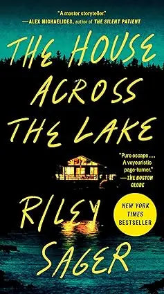 The house across the lake book cover features glowing yellow text and a lit house silhouette against a teal night sky