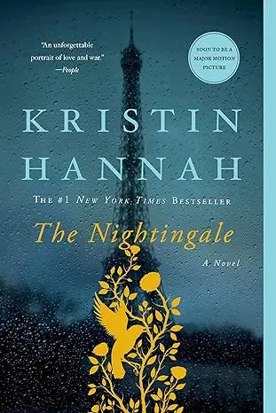 The nightingale a novel hardcover book with a dark blue cover and gold foil eiffel tower and yellow birds design