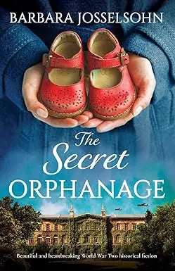 Hands holding red perforated leather children’s shoes featured in the secret orphanage product image