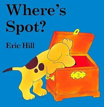 A yellow puppy with black spots peers into an orange treasure chest in the lift the flap book where’s spot